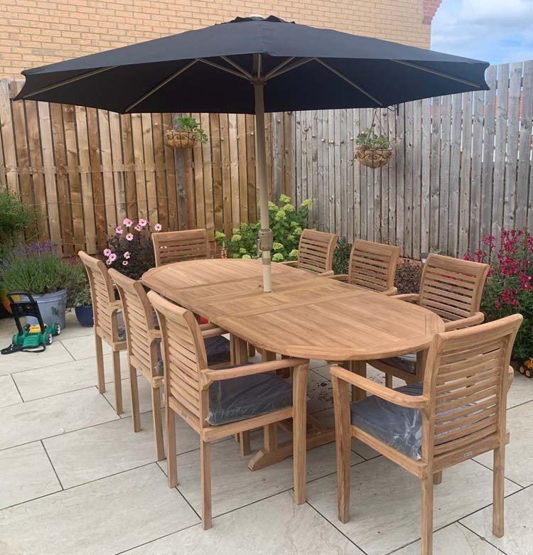 Double extendable table 1.8m to 2.4m, 8 x teak stacking chairs, free 3m parasol and cushions